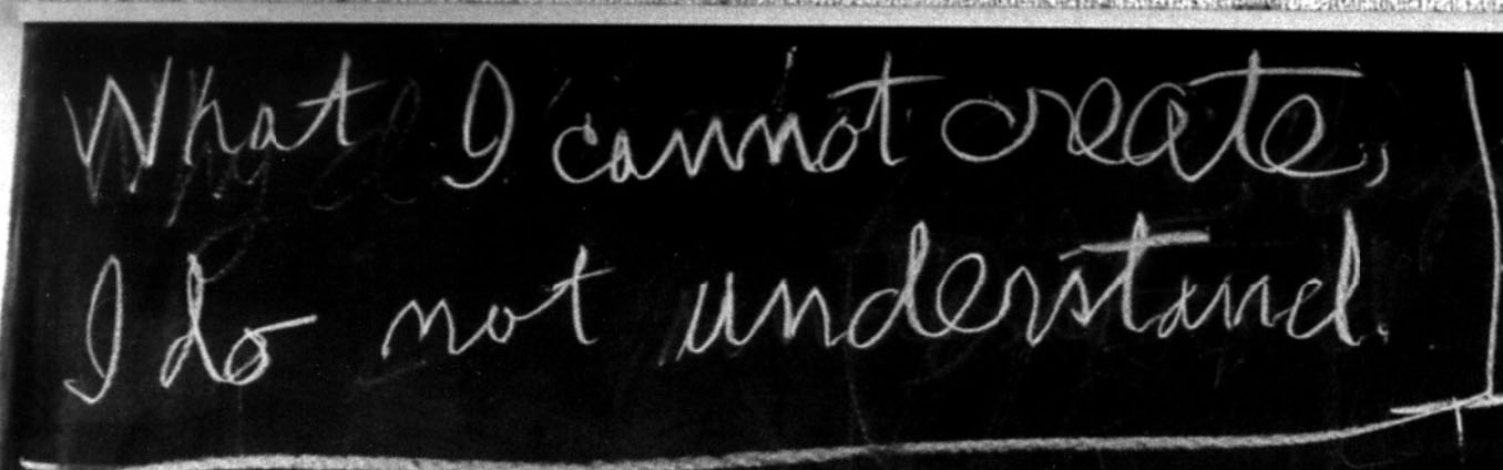 Chalk handwriting on a blackboard reading: What I cannot create, I do not understand.